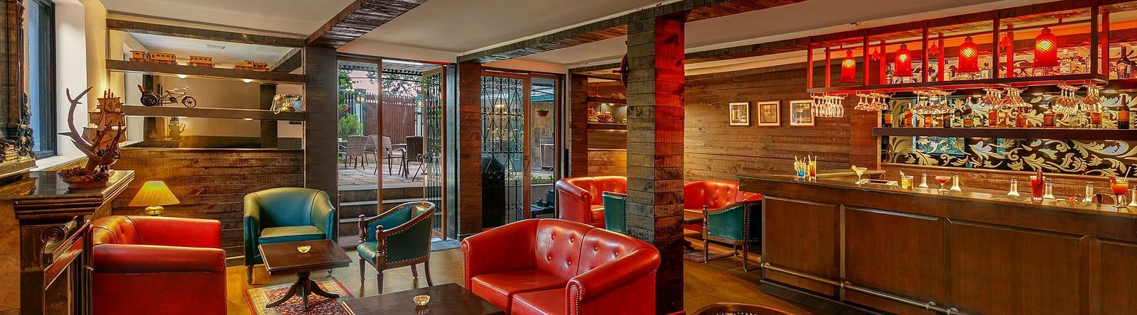  A image of a resturant with tred lighting with table and chair setting well decorated with bar also present at Shervani Hiltop 
