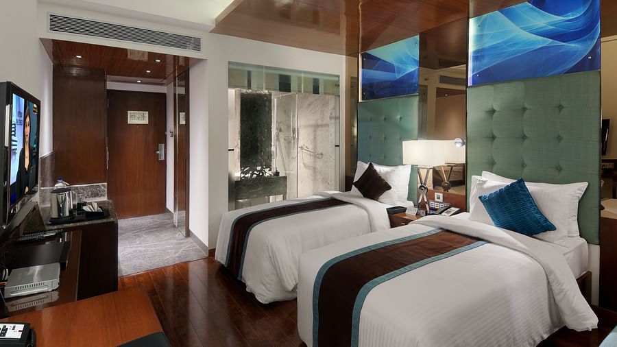  Twin bed room with modern art wall and ambient lighting at The Elanza Hotel.