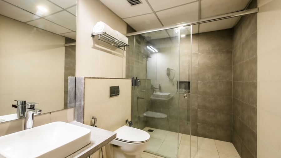 A clean and contemporary bathroom with a glass shower enclosure and a modern basin, ready for use at Shilton Dee Cee.