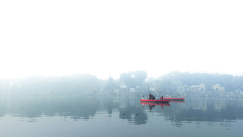 A far out view of Yamuna River with a solitary boat in view.