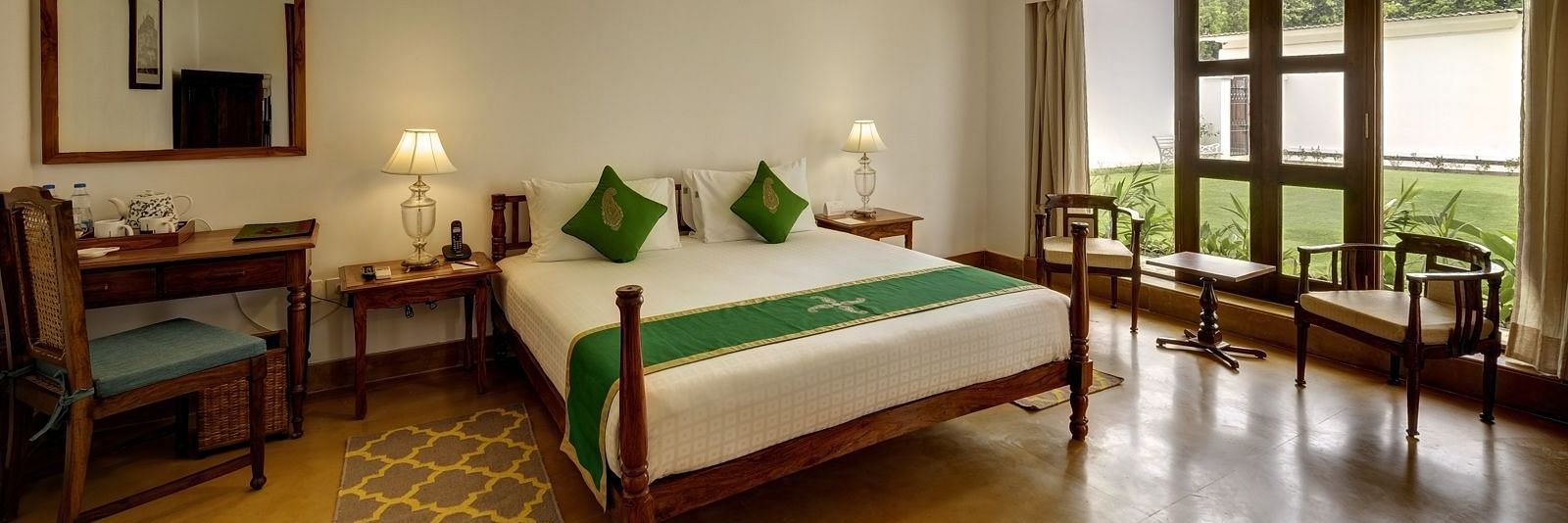 Residency Room with a double bed and a work desk and chair at Saraca Hotel, Lucknow
