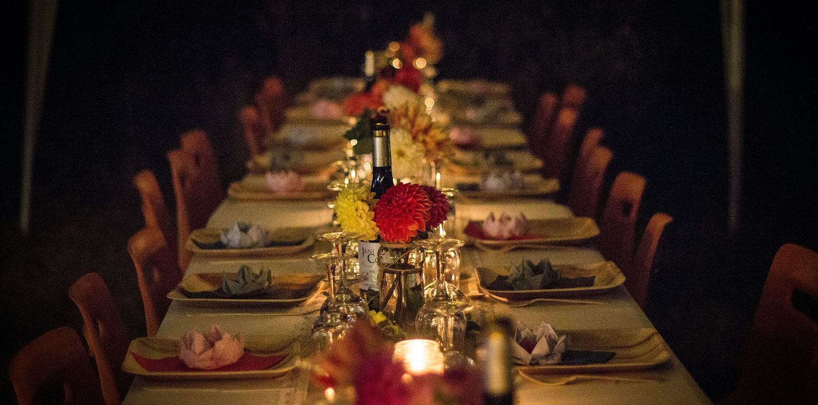 A dimly lit, elegant dinner table set for a formal event at Ramoji Film City Hotels in Hyderabad 