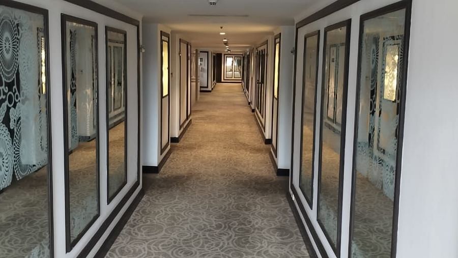 Contemporary hotel corridor at St Marks Hotel with sleek glass paneling and clean design