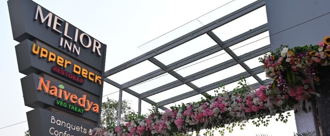 An exterior view of the entrance of Melior Inn with signage and some decoration.