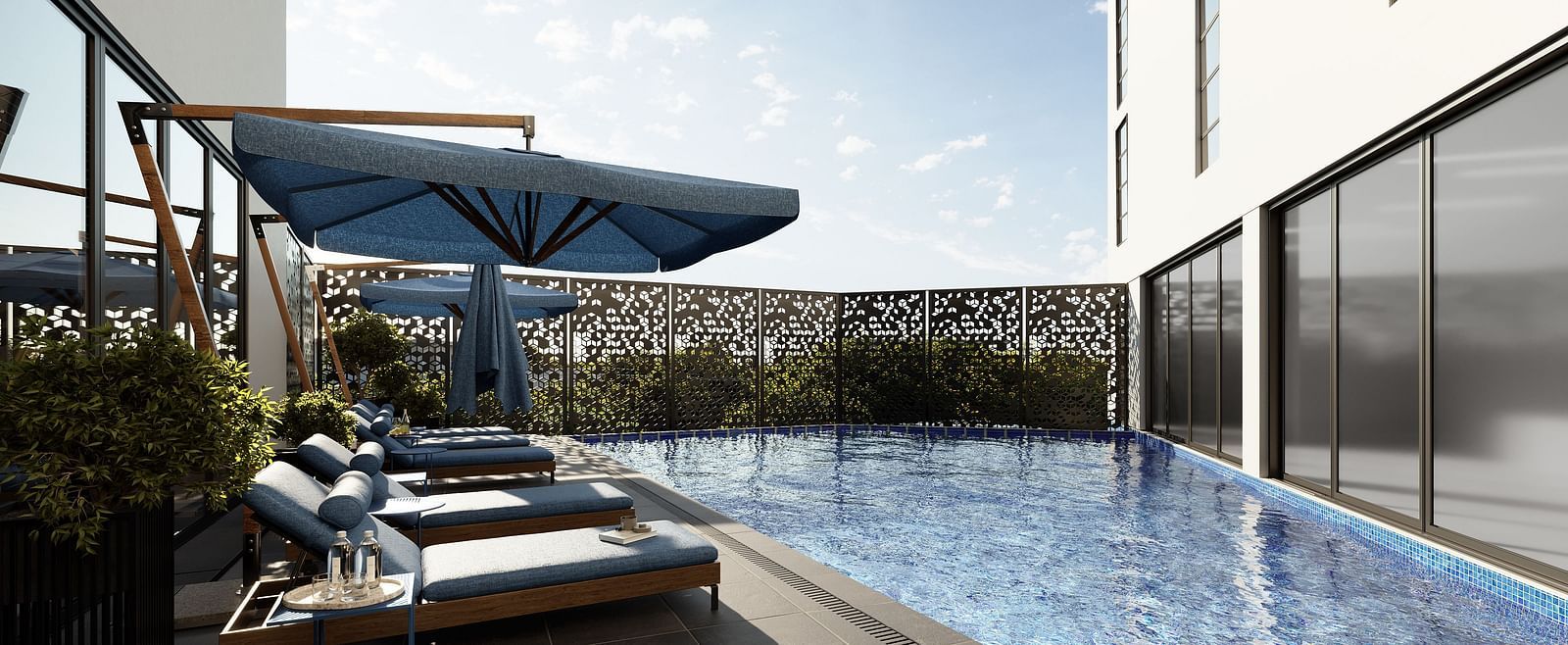 A swimming pool next to lounging chairs at The Pelican Hotel, Accra.