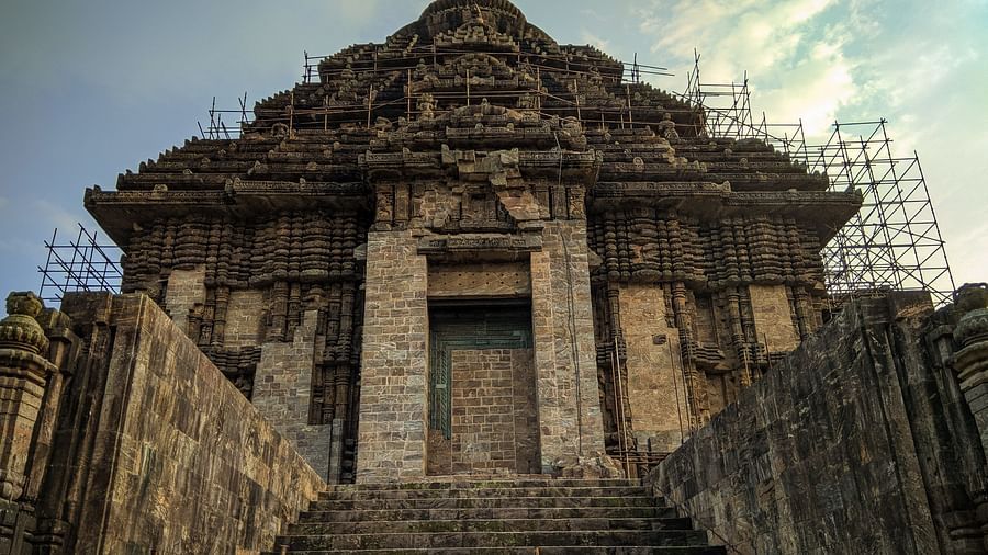 A close up and low angle facade view of temple under renovation/