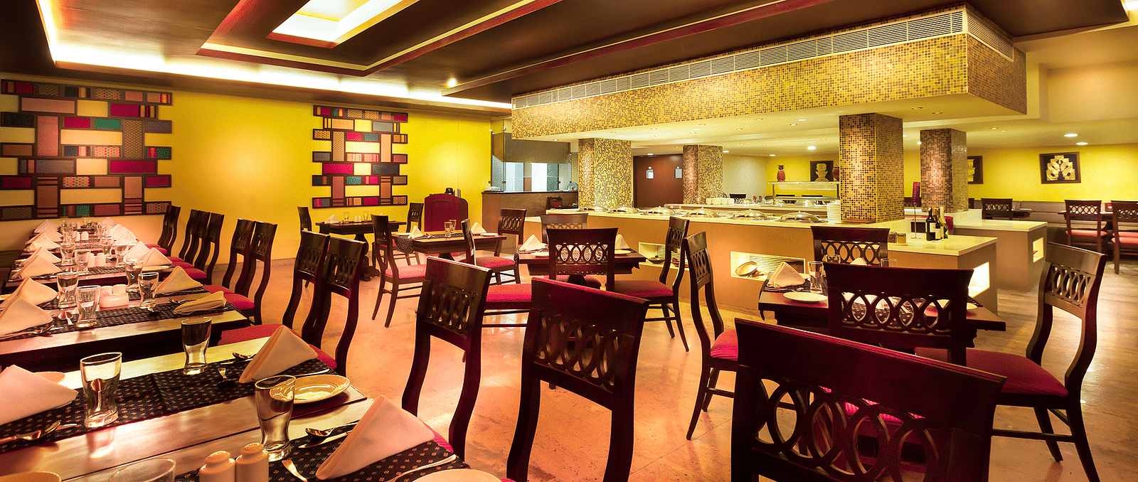 An image of a dining space with tables and chairs at Regency Madurai by GRT Hotels