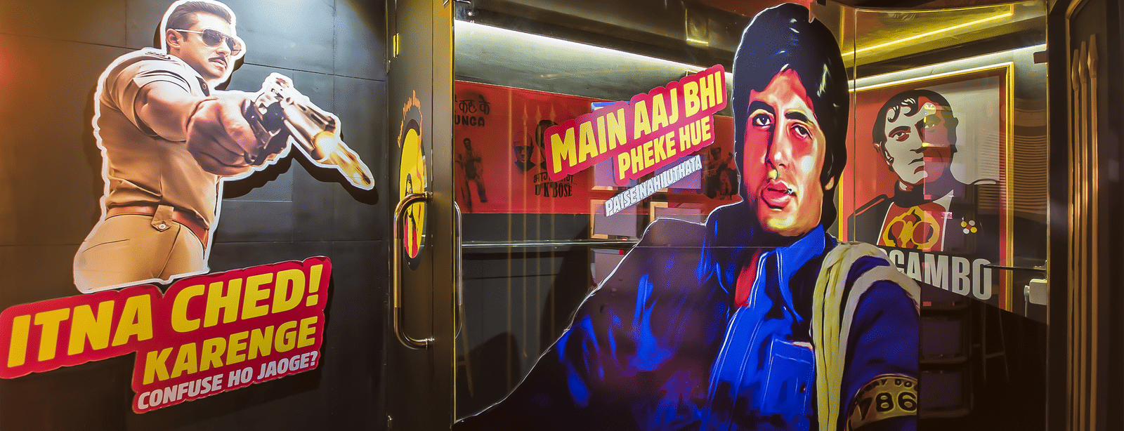 A wall mural featuring Bollywood actors with text 'ITNA CHED KARNEKA' at Infiniti Hotel, Indore.