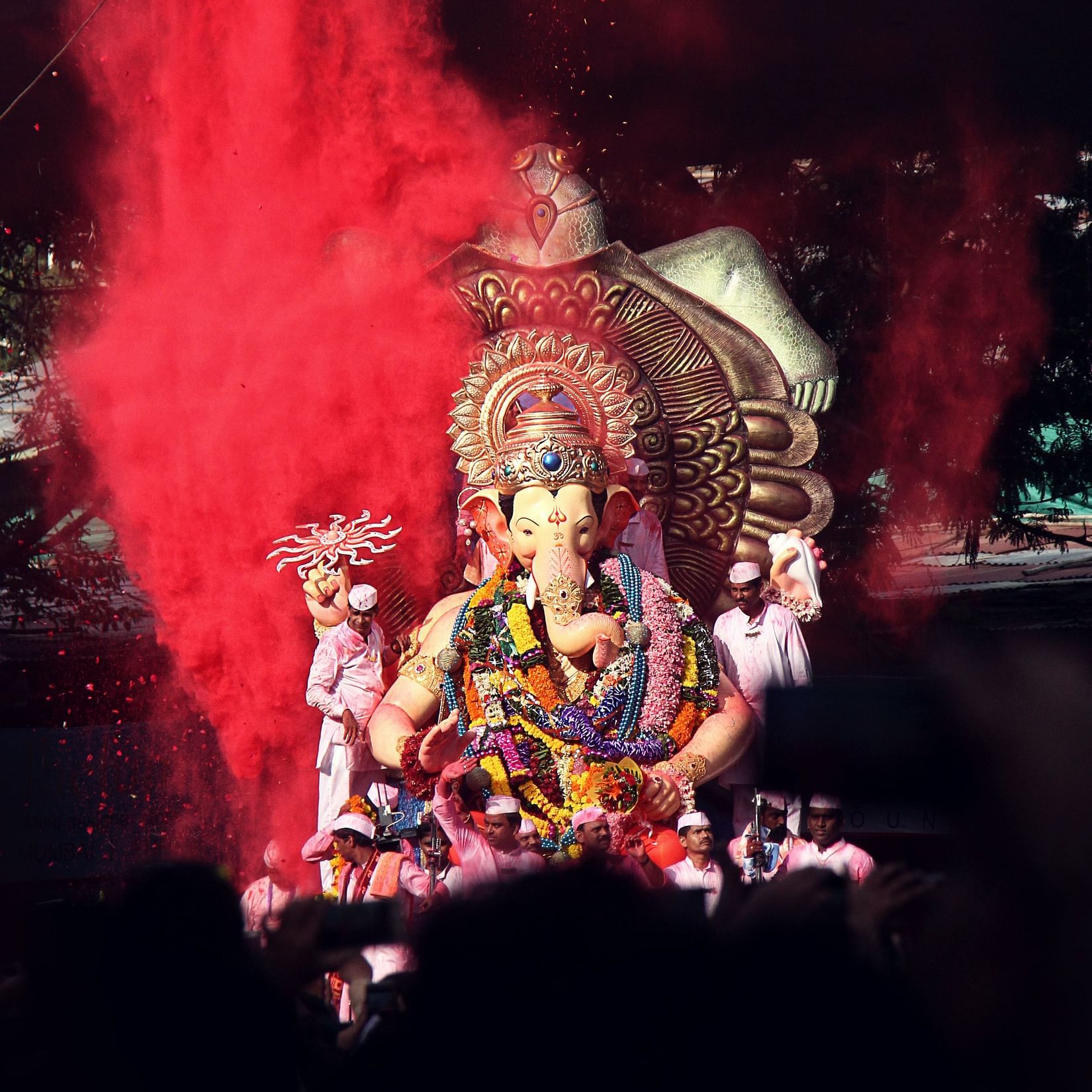People accompanying a huge idol of Lord Ganesh for the procession