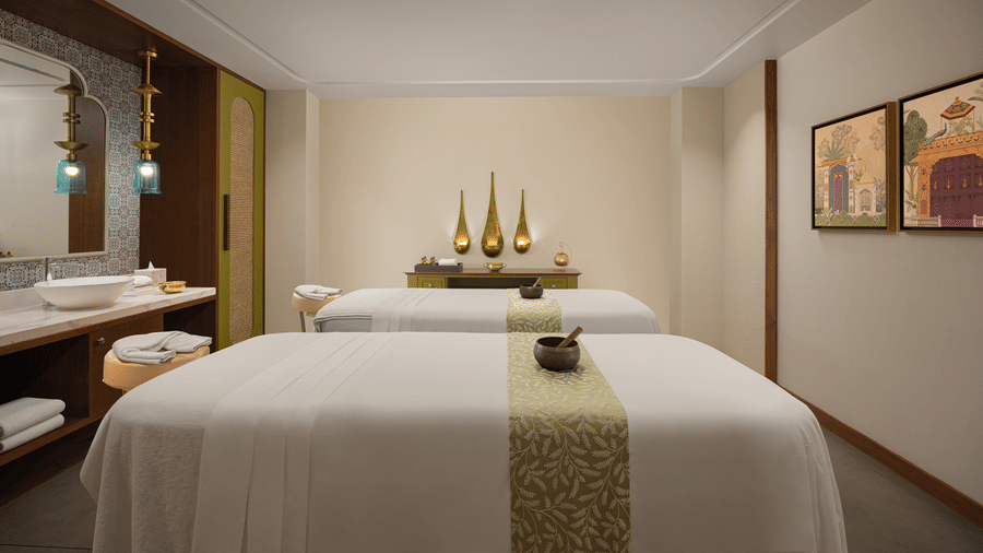 Spa room at Aloha on the Ganges with two massage tables and warm lighting