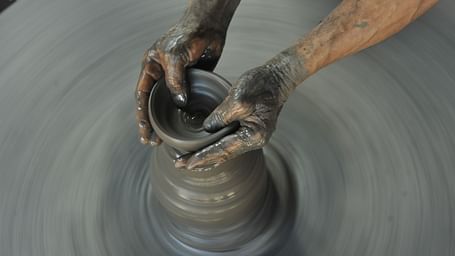 A pair of hands doing pottery