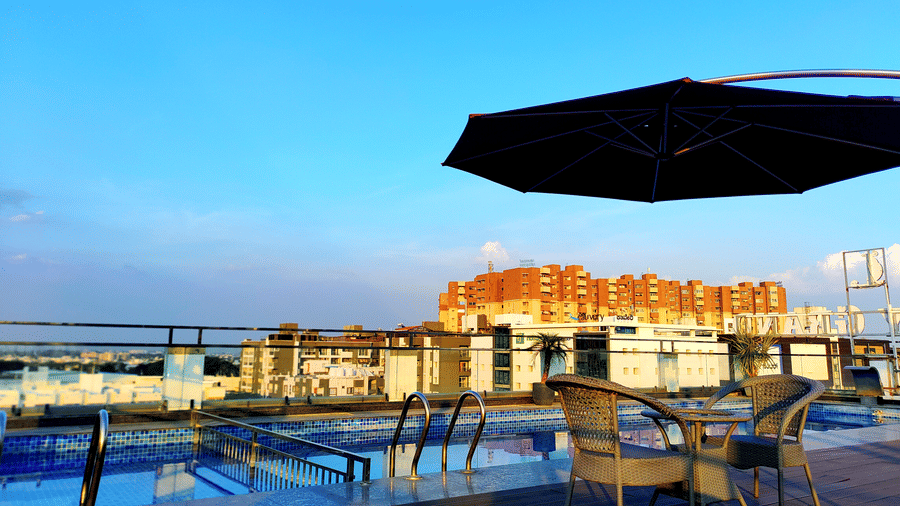 Kensho rooftop pub by the pool overlooking the beautiful blue sky in the background at Leroy Grand, Yeshwanthpur.
