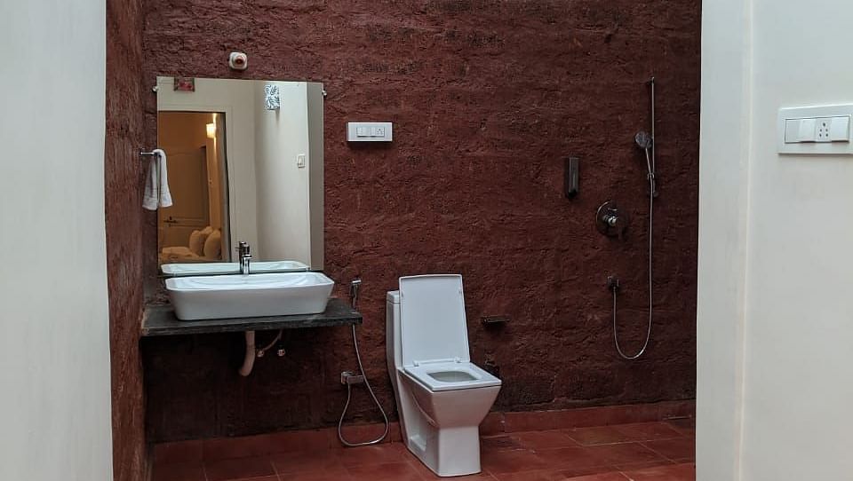  A spacious bathroom with a skylight, featuring a toilet and a sink at The Conservancy Bungalow.