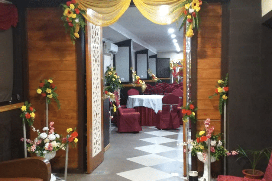Stylish banquet entrance with golden drapes, floral accents, and a welcoming ambiance at Central Courtyard Boutique Hotel.