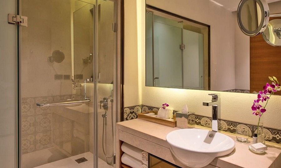 alt-text Bathroom with glass shower cubicle and a large mirror
