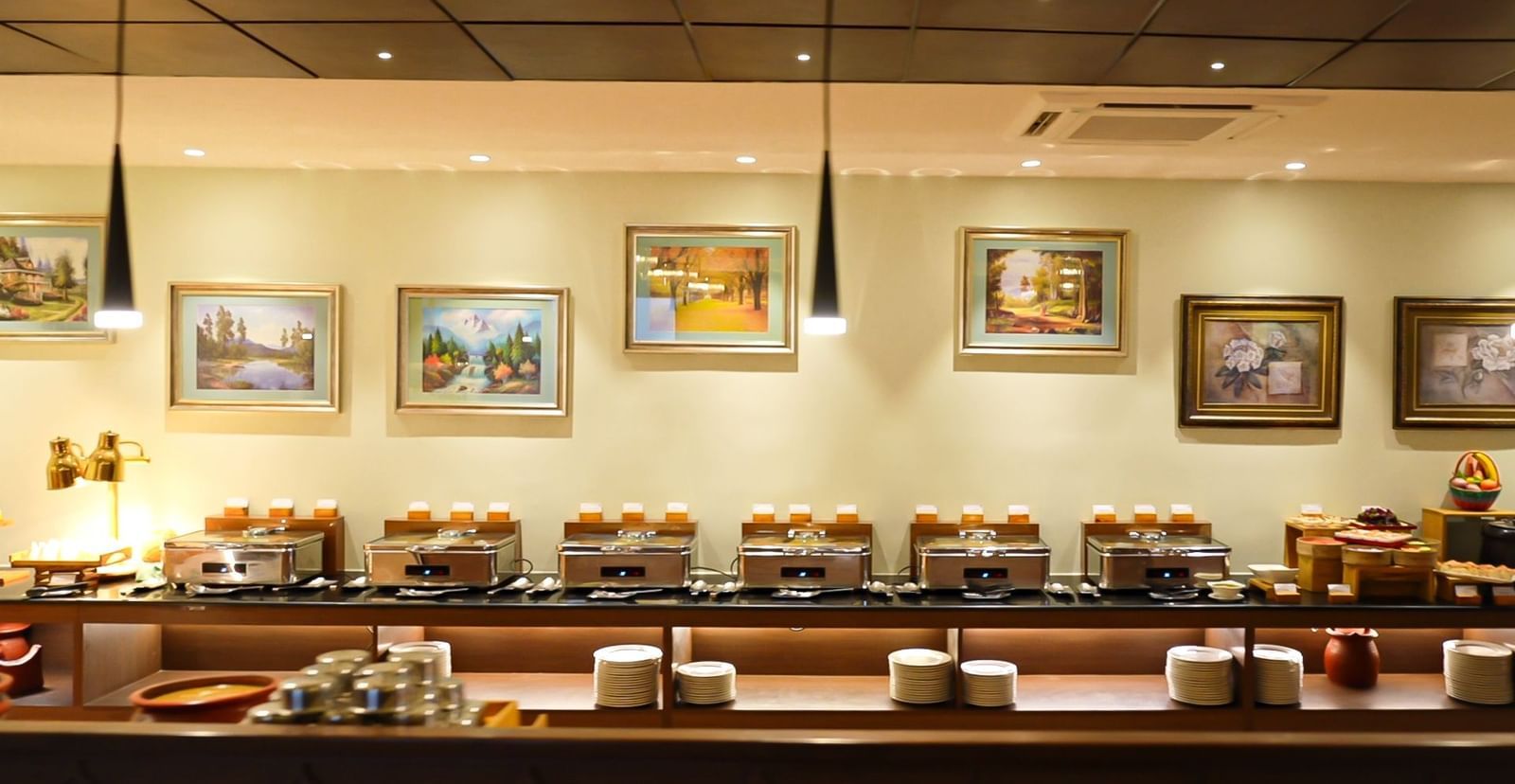 A restaurant's interior featuring framed artwork and wooden accents on walls and ceiling - Accord Chrome Airport Hotel