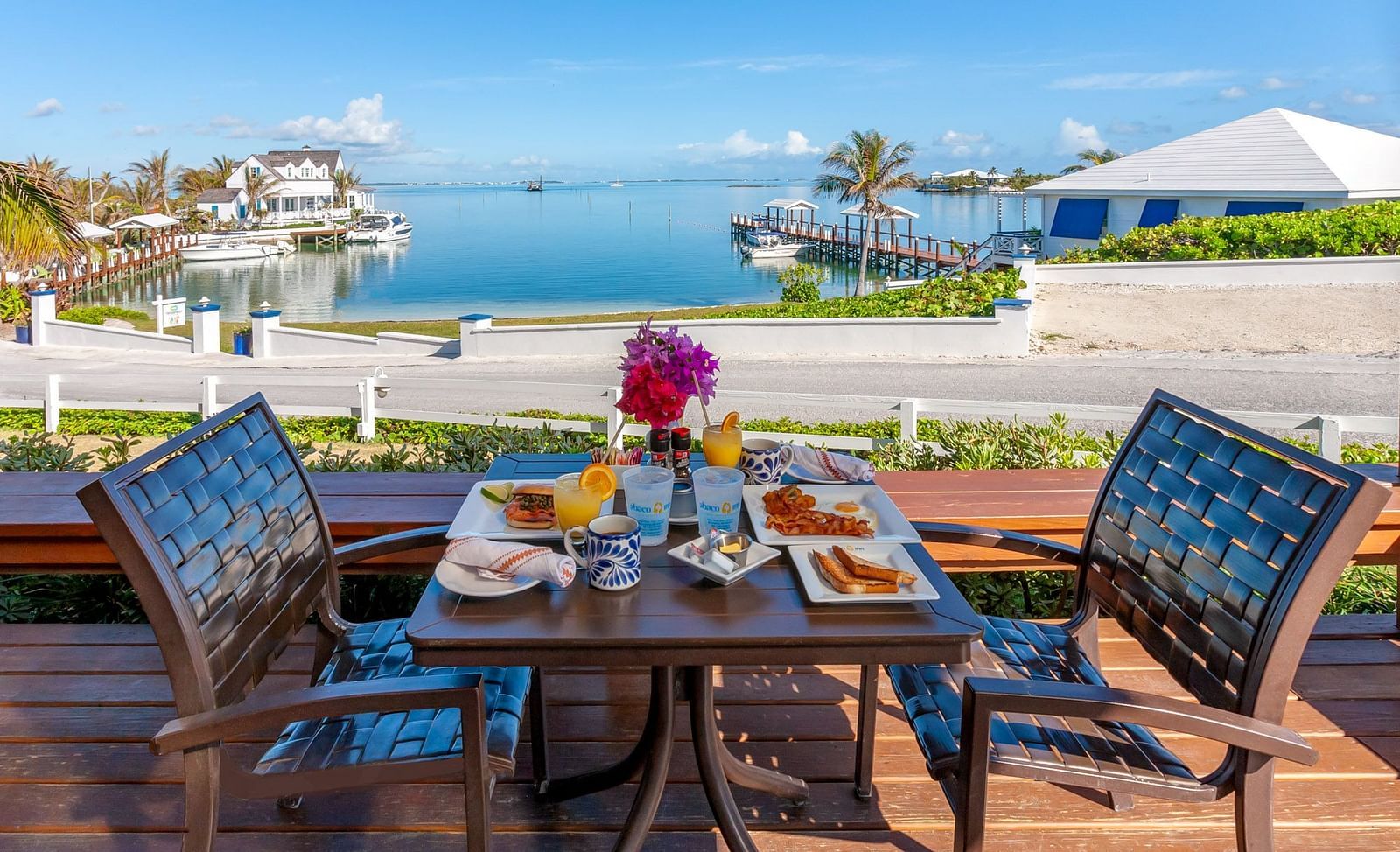 Outdoor breakfast setup with ocean view in the background | Abaco Inn
