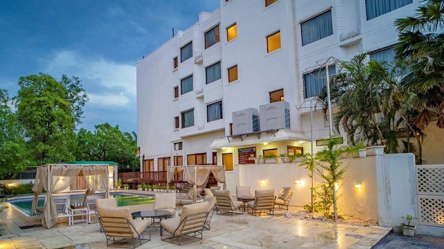 Evening view of the hotel building and poolside setup at Golden Tulip, Udaipur.