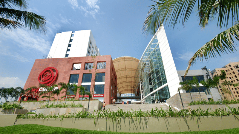 The modern architectural exterior of City Centre Mall in Kolkata, featuring wide steps and a large logo.