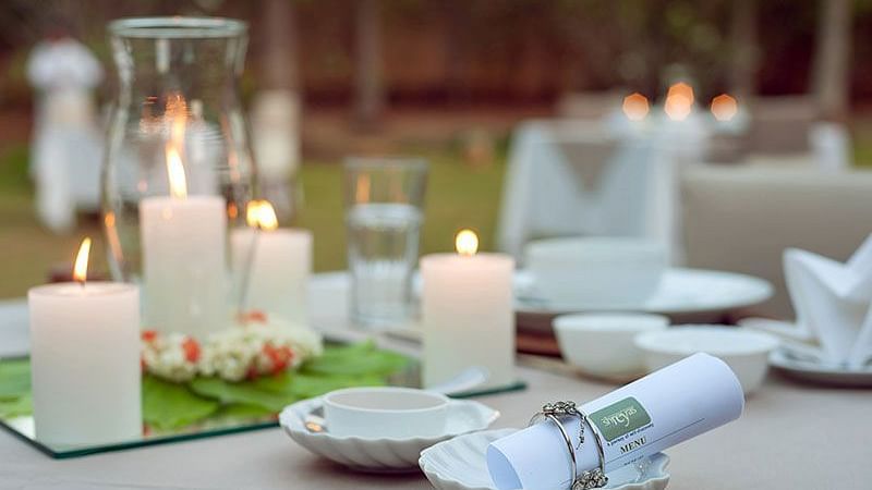 A table set with candles and small bowls, outdoor setting - Shreyas Retreat