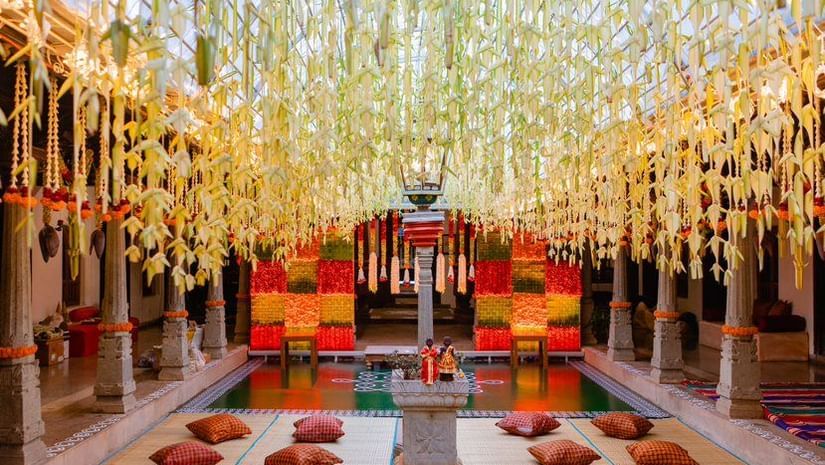 An overview of a courtyard inside Chidambara Vilas, with cushions on the floor and decorations around at one of the best Chettinad wedding venues.