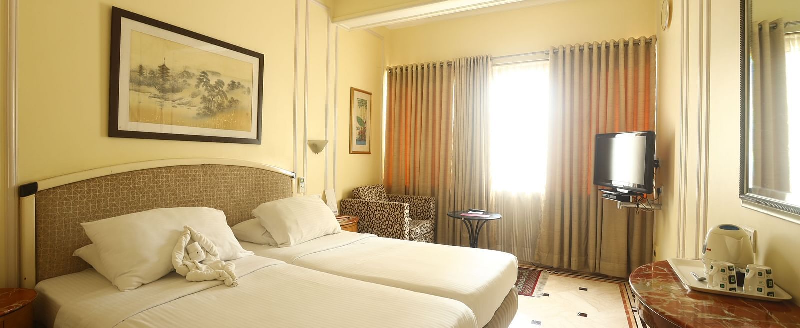 Twin beds in the Standard Room at Regency Hotel, Mumbai.