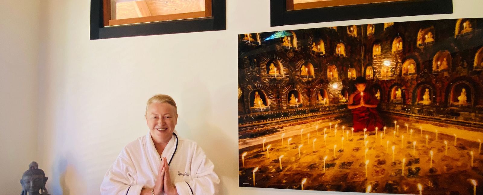 A guest in white robes posing for the camera in the spa at Brewery Gulch Inn & Spa