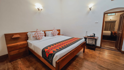 An overview of the Mayfair Suite Main Bedroom with a double bed - Ibex Stays & Trails, Coonoor (Leewood).