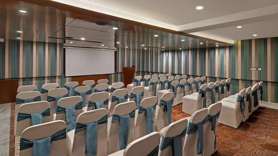  Seminar room with theatre-style seating and large projection screen at The Elanza Hotel.