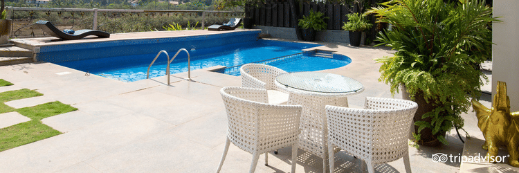 swimming pool with white chairs  at White Pearl Resort by Rosetum