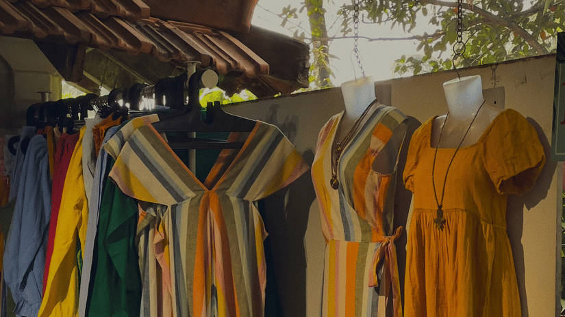 Boutique clothing display featuring colourful dresses and apparel at a shopping market in Goa.