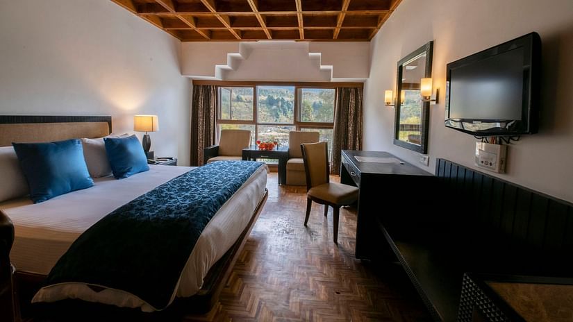 a view of Duplex at Mastiff Grand, Manali featuring wooden furnishing and comfy bed