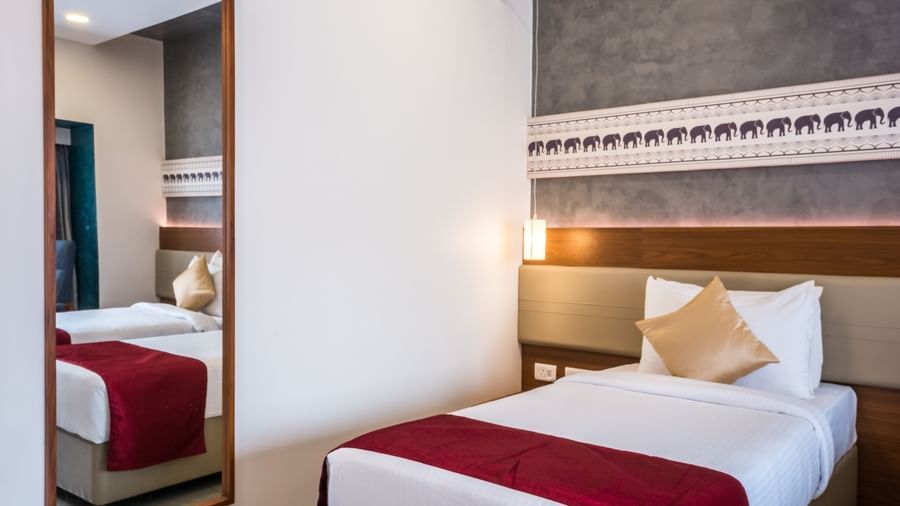  A well appointed hotel room featuring a single bed, a full length mirror, and a modern headboard at Shilton Dee Cee.