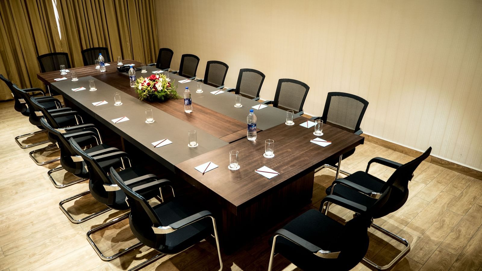 The board room with a huge table surrounded by chairs at Grand Ashok, Thanjavur.