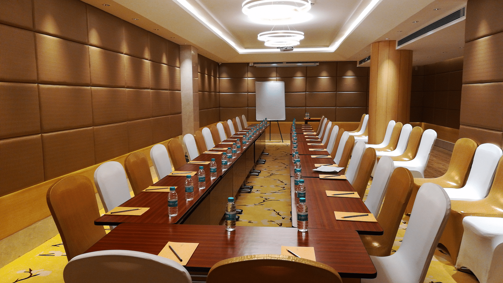a meeting hall with a long rectangular table with chairs surrounding it - Hotel Fountain Tree By TGI - JP Nagar, Bangalore