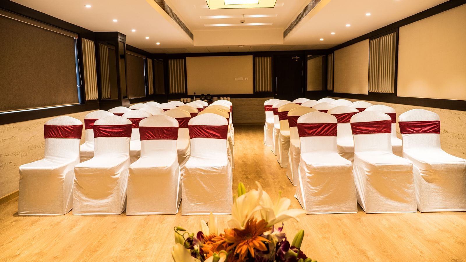 event hall with white satin chair and red ribbon of MM Legacy, Kanchipuram