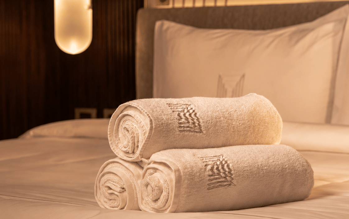 Warm Luxury Hotel Bed with Rolled Towels