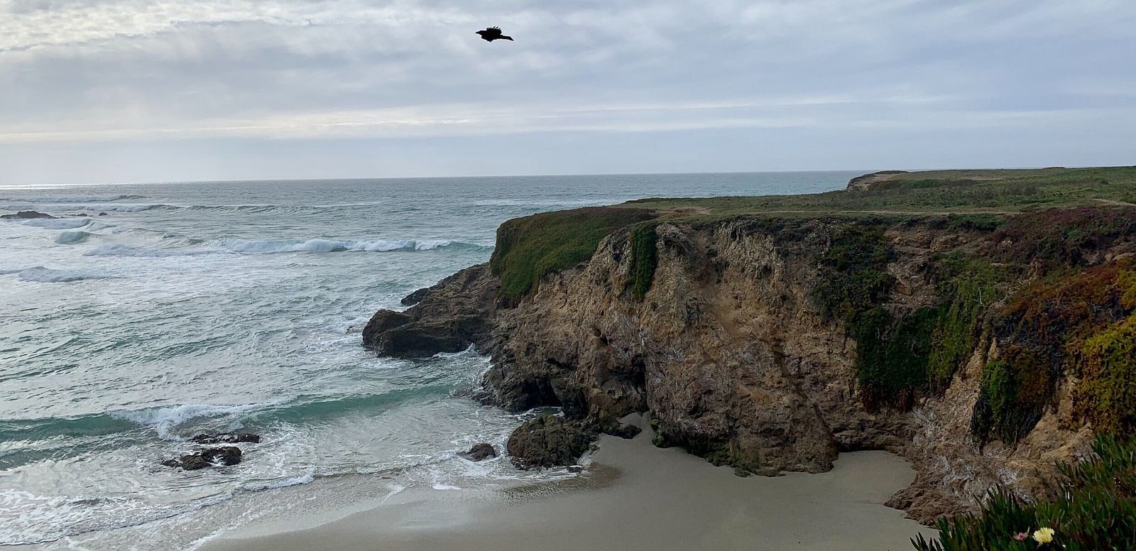 An image of a cliff and beneath is a river