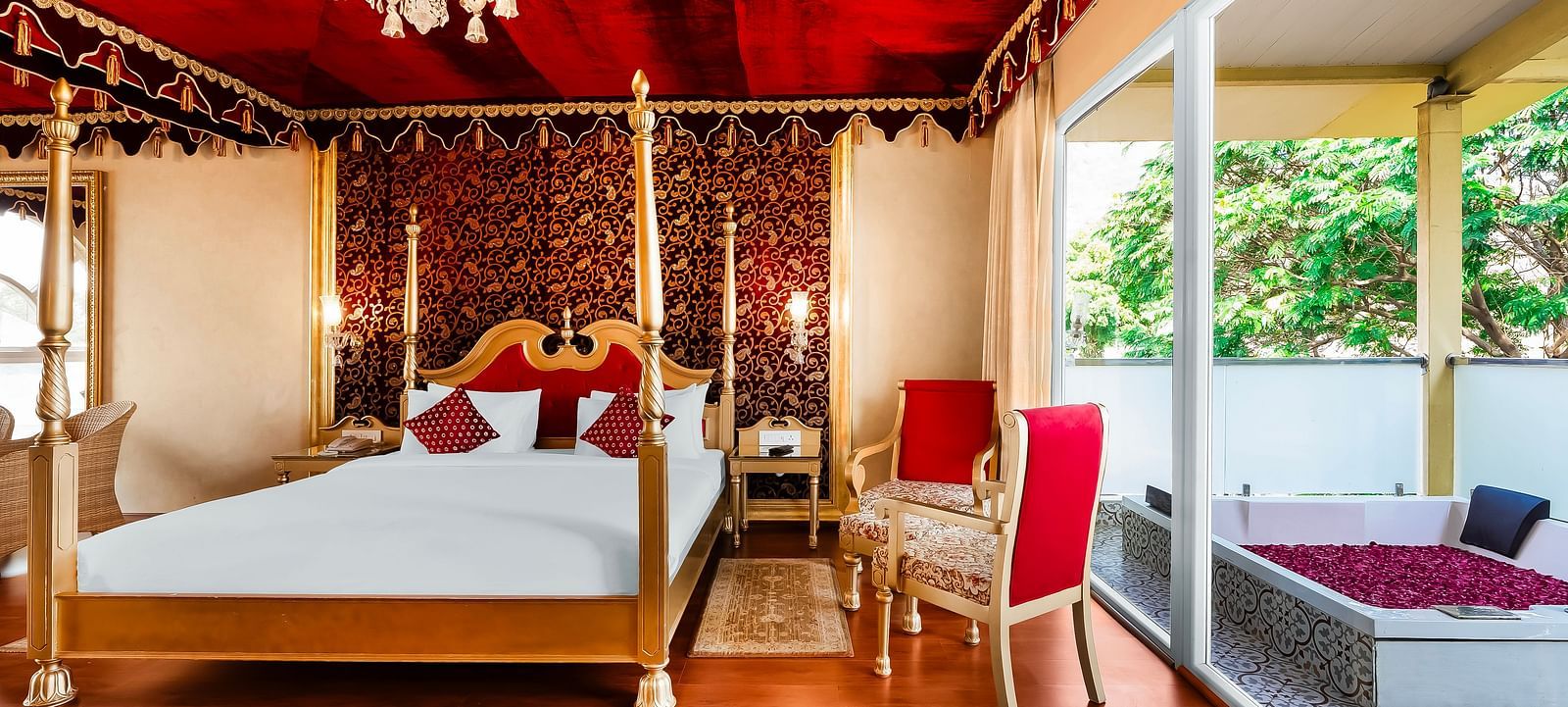 An overview of a room with a double bed, chairs and a bathtub outside - Rajasthali Resort & Spa, Jaipur.