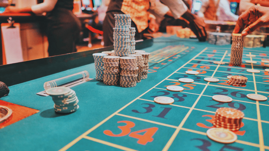 poker chips placed on a blue poker table