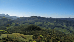  A panoramic view of a mountain range covered in lush greenery.