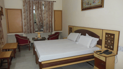 Hotel Taj Plaza Agra Taj Facing Superior Room featuring double bed with furniture and telecom on the nightstand