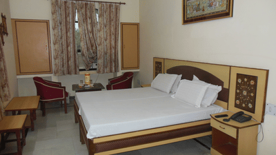 Hotel Taj Plaza Agra Taj Facing Superior Room featuring double bed with furniture and telecom on the nightstand