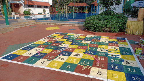 A play area with a large painted floor game at best resort in Bangalore | Ramanashree California Resort