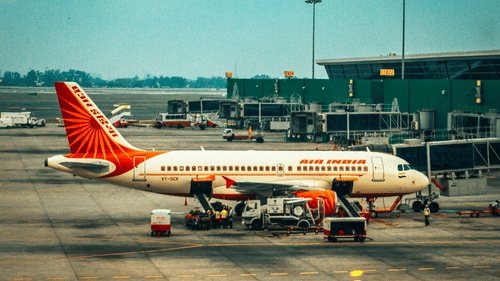 An AirIndia aircraft parked at the ramp during the day time.