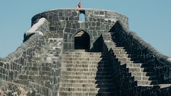 The stairs and architecture of Madh Island fort with the blue sky in the background