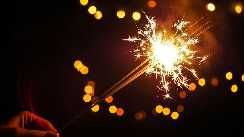 A person holding a sparkler during the festival of Diwali