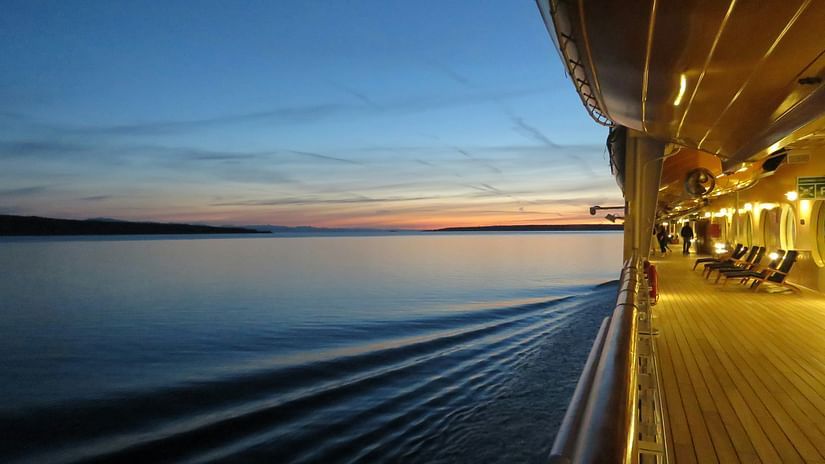 A water body on the left and the inside of a marine vessel on the right in view.