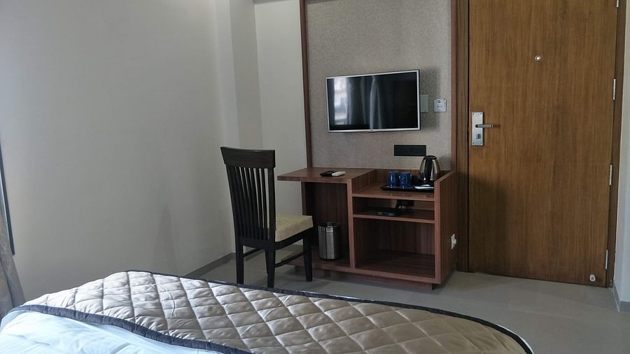 Premier With Breakfast room featuring a bed, TV and a desk| Kyriad Hotel, Solapur