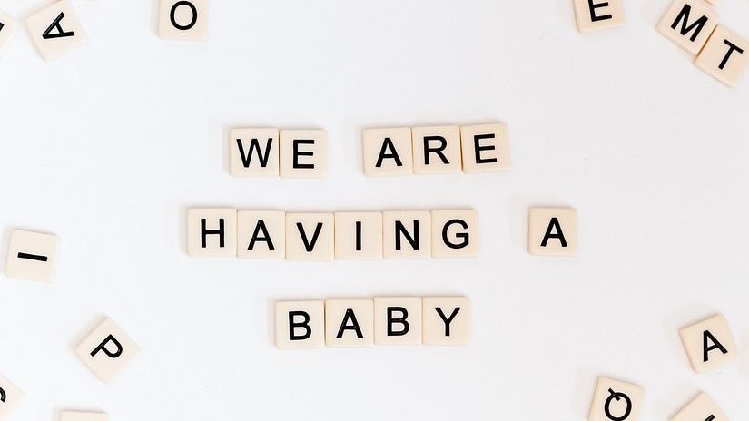 crossword tiles laid out saying we are having a baby at Azaya Beach Resort - the best resort for baby shower in goa